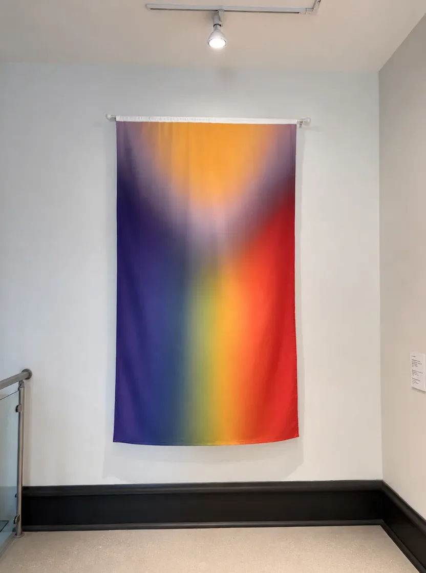 The 5790/2029 Pride Flag by Will Montgomery installed as a tall hanging banner at the Right to Assemble exhibition, The Center on Addison, Chicago, June 2026