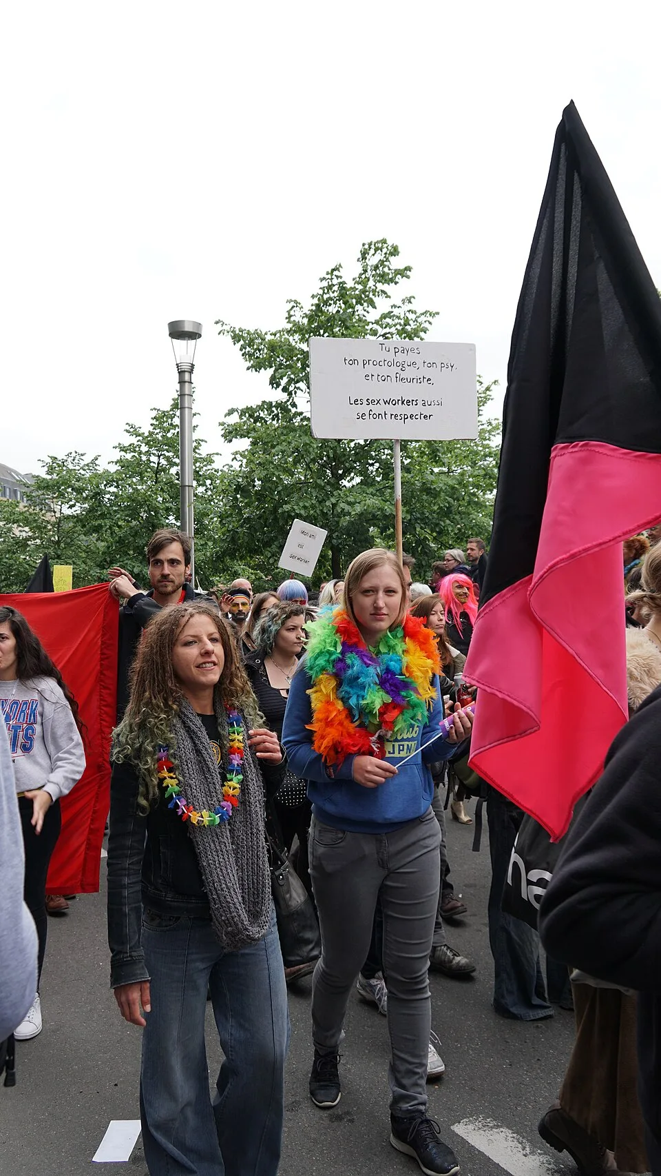 A pink and black diagonal flag held above the crowd at Belgian Pride in Brussels.