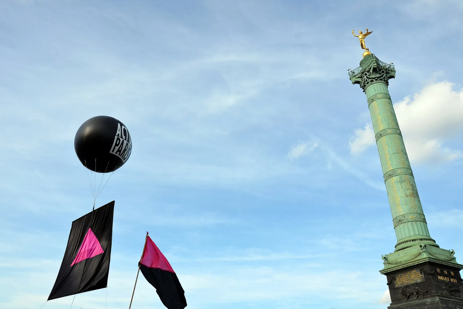A pink and black diagonal flag carried at the Paris Pride march.