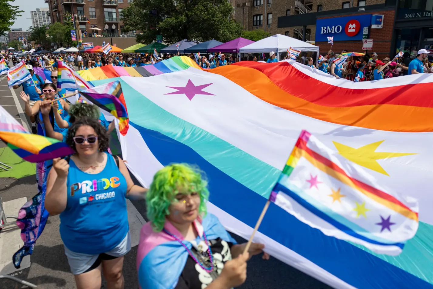 Participants carry a large-format Chicago Pride Flag banner during the 55th annual Chicago Pride Parade, June 28, 2026, in the Lakeview neighborhood