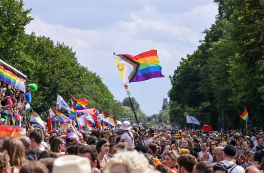 Crowds marching at Christopher Street Day with Progress Pride Flags visible, Berlin, July 22, 2023