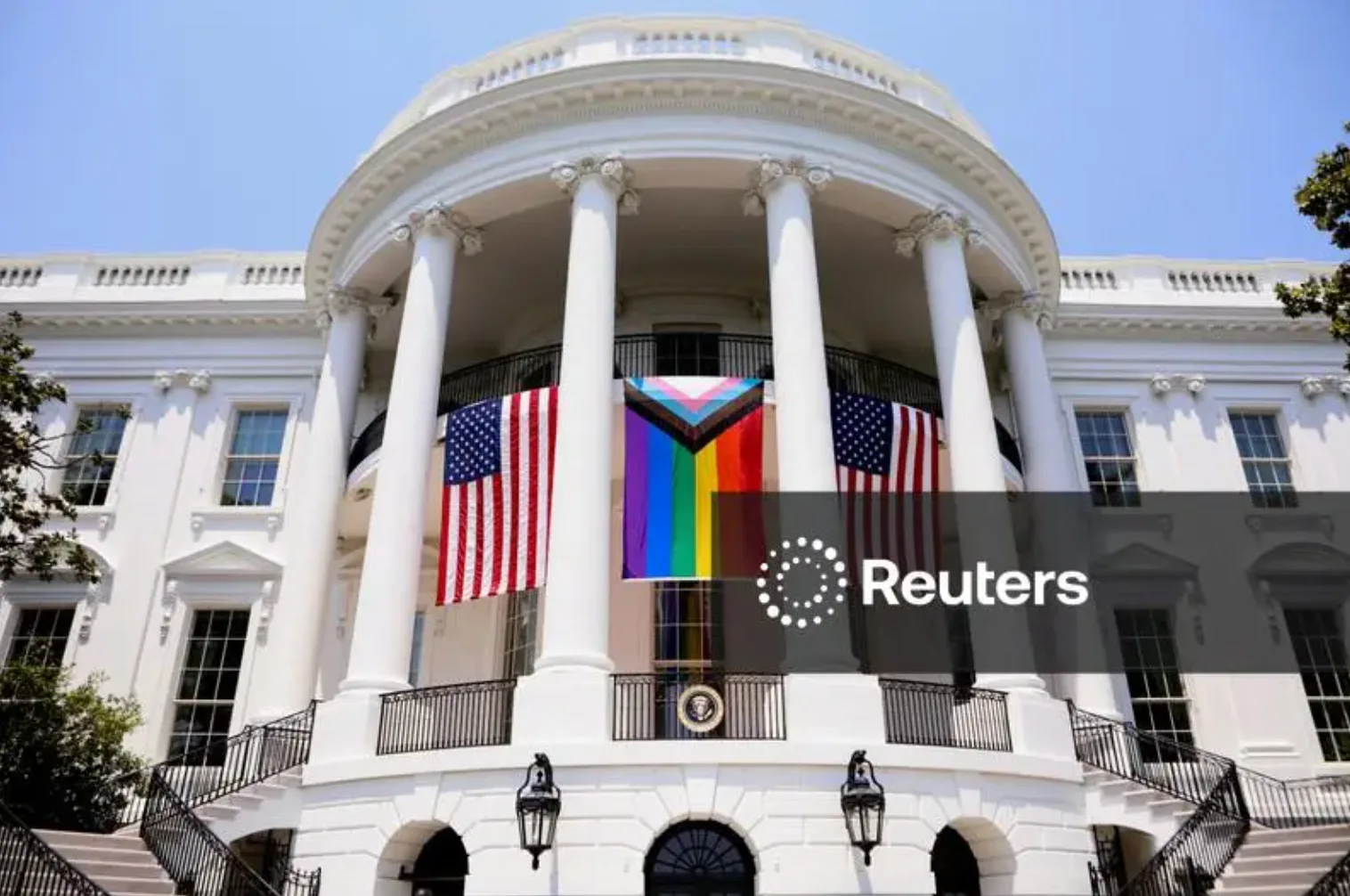 Intersex-Inclusive Progress Pride Flag displayed from the White House balcony flanked by American flags during a Pride celebration, Washington, DC, June 10, 2023
