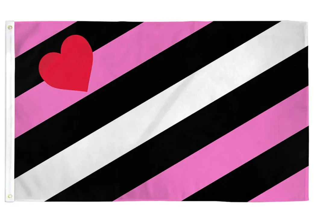 A flag of diagonal stripes running upward from the lower hoist, alternating black, pink and a central white band, with a tilted red heart in the upper hoist corner and two brass grommets on the white hoist band.