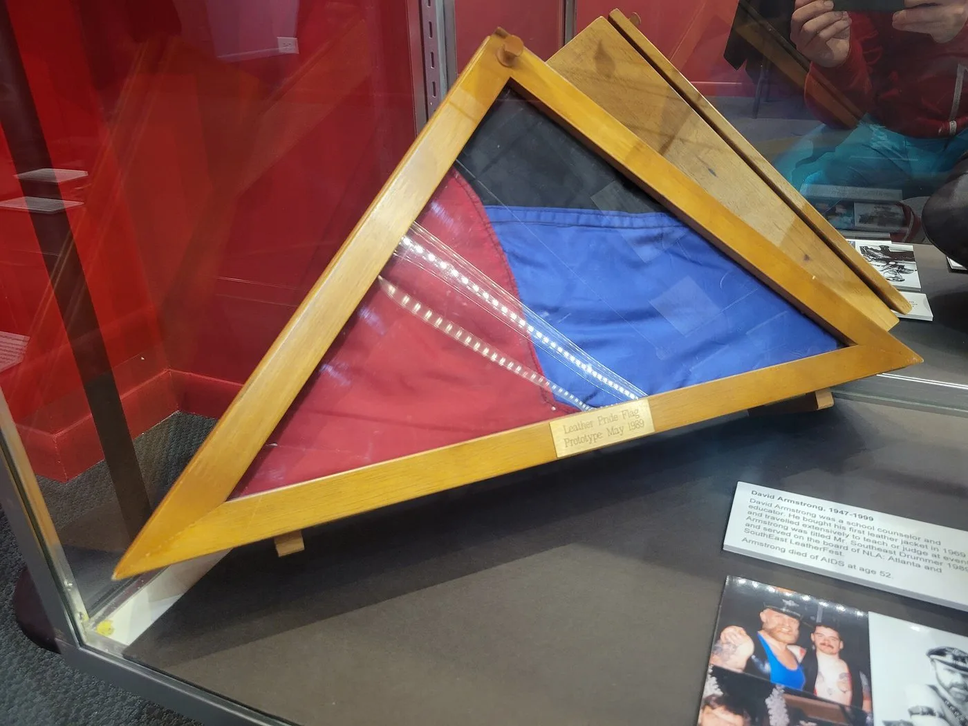 One of the three original 1989 leather pride flags assembled by Tony DeBlase, folded into a triangular display case at the Leather Archives & Museum in Chicago.