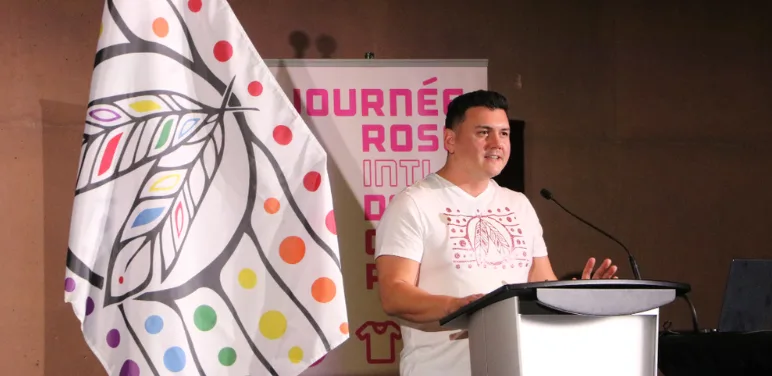 Patrick Hunter unveils his Two-Spirit pride flag design at a Day of Pink event in 2024.