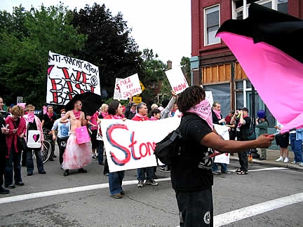 A marcher at the 2003 Pittsburgh Gay Pride parade carrying a flag divided diagonally into black and pink.