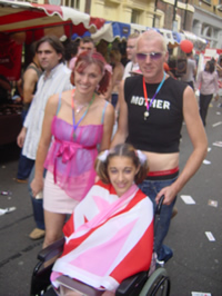 A group on a London street during EuroPride 2006, a child in a wheelchair wrapped in a Pink Jack.