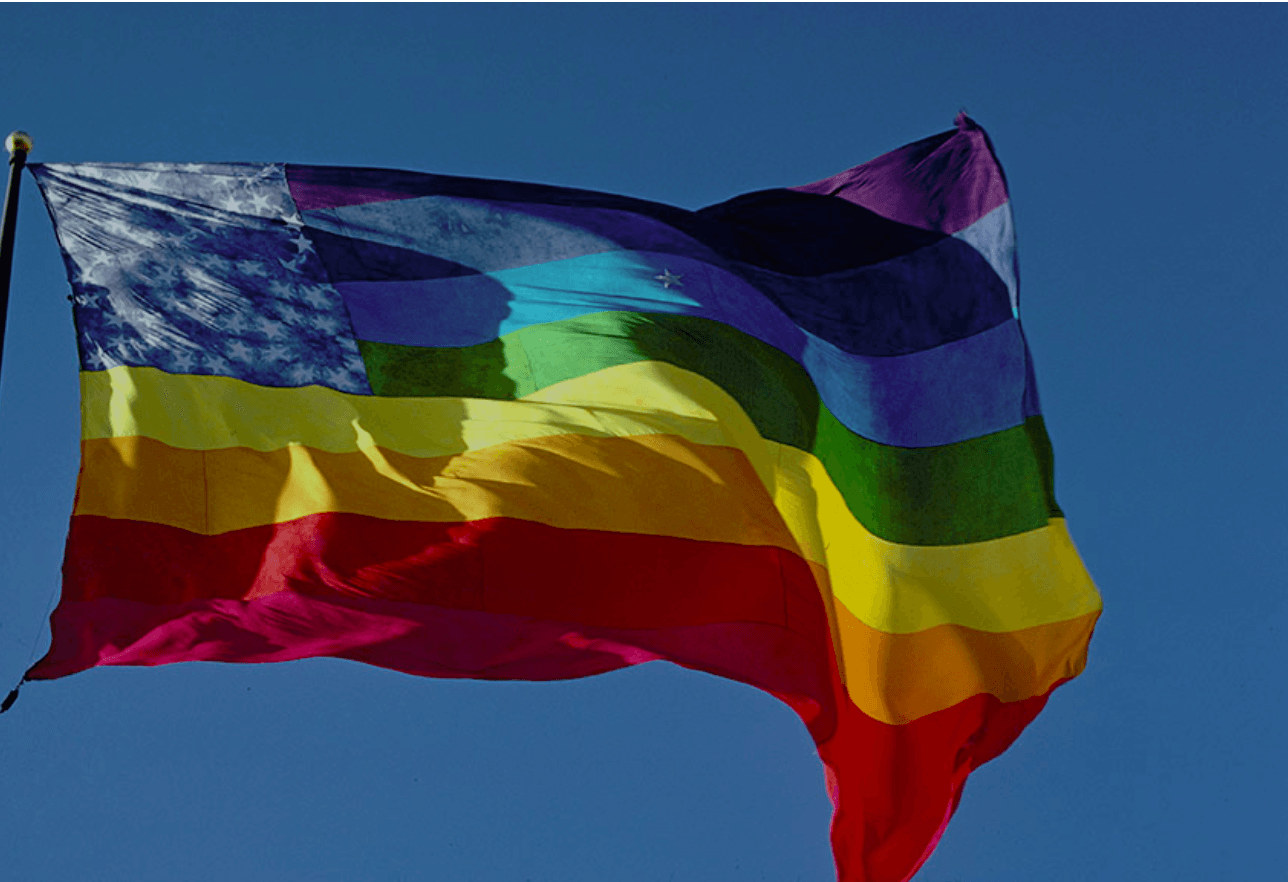 The stars-and-stripes rainbow flag variant flying from a tall flagpole at the entrance to United Nations Plaza in 1978.